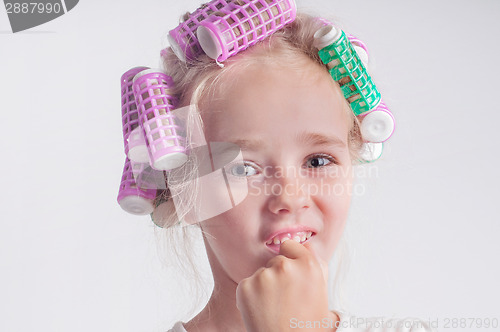 Image of Cute child girl portrait in curlers