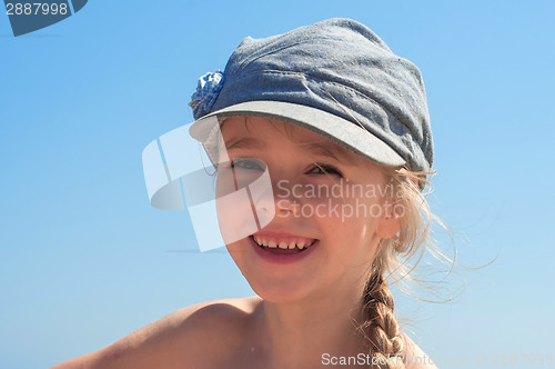 Image of Adorable happy little girl in denim cap