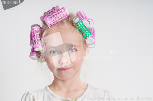 Image of Adorable child girl portrait in curlers