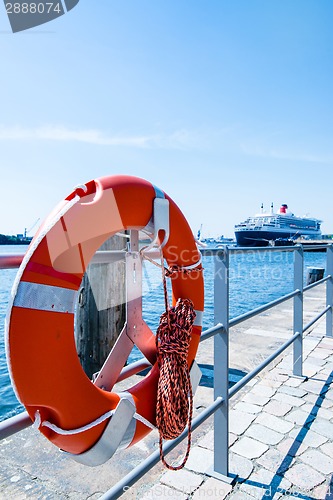 Image of Red Lifebuoy in front of cruise ship