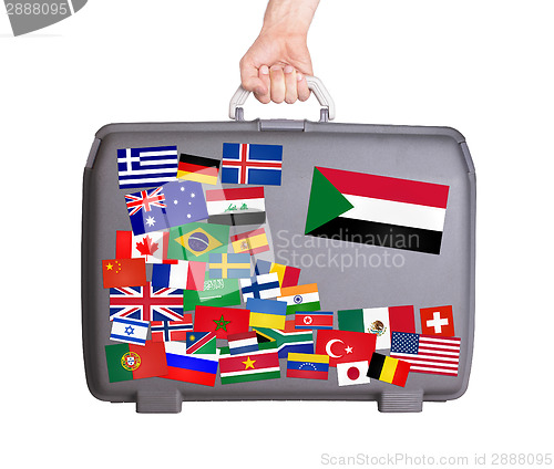 Image of Used plastic suitcase with stickers