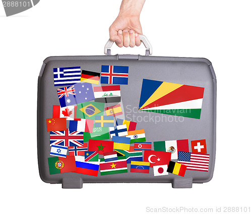 Image of Used plastic suitcase with stickers