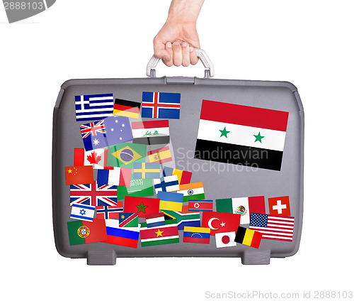 Image of Used plastic suitcase with stickers