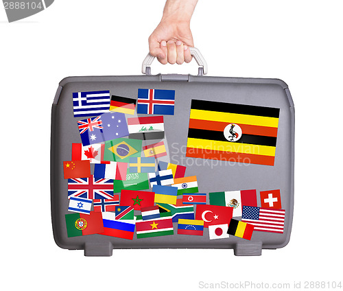 Image of Used plastic suitcase with stickers