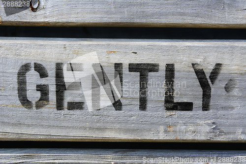 Image of GENTLY stencilled in capitals on wood