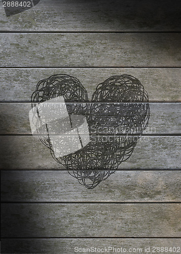 Image of Heart scribbled on a gray weathered wood