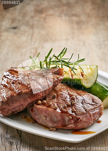Image of grilled beef steak on white plate