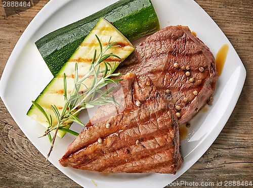 Image of grilled beef steak on white plate