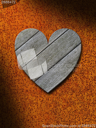 Image of Weathered gray wood heart against rusty metal background