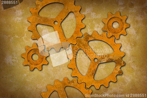 Image of Rusty gears against a mottled yellowish background