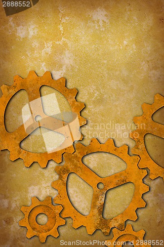 Image of Rusty gears against a mottled yellowish background