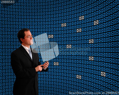 Image of Man monitoring an array of email icons