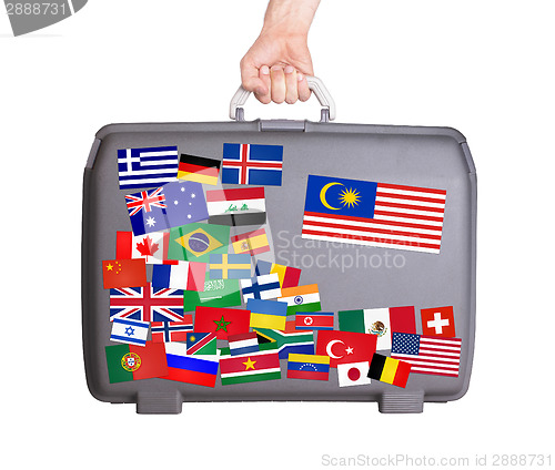 Image of Used plastic suitcase with stickers