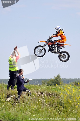 Image of The motorcyclist on the motorcycle participates in race on a cro
