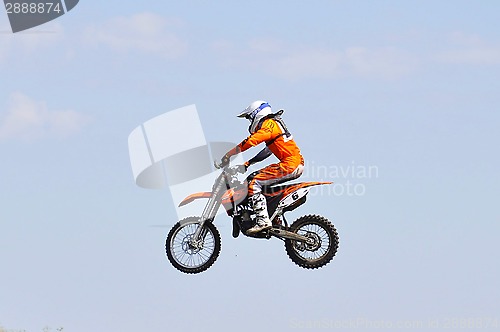 Image of The motorcyclist on the motorcycle carries out a jump against th