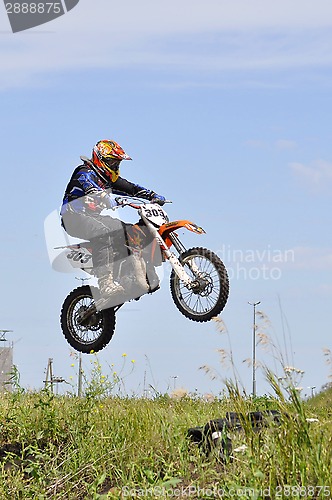 Image of The motorcyclist on the motorcycle carries out a jump against th