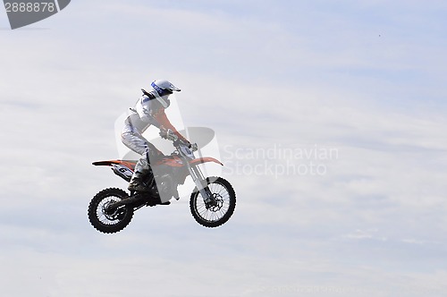 Image of The motorcyclist on the motorcycle in a jump against the sky.