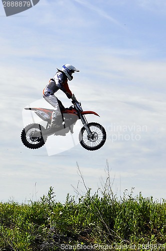 Image of The motorcyclist on the motorcycle in a jump against the sky.