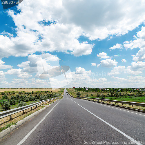 Image of asphalt road goes to cloudy horizon