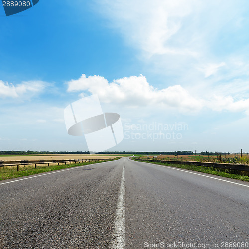Image of cloudy sky over asphalt road