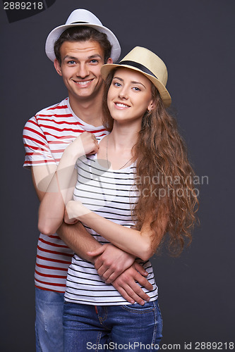 Image of Young casual couple hugging