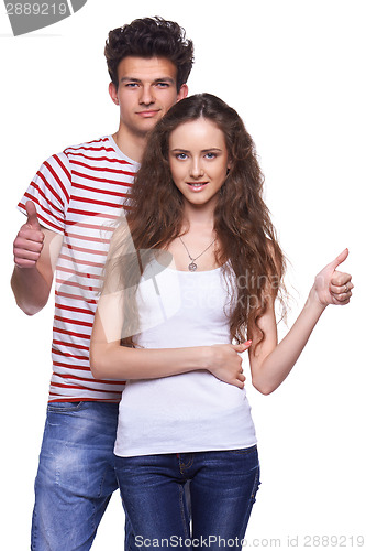 Image of Young casual couple giving thumbs up