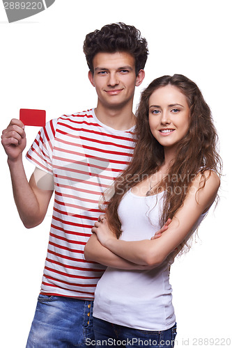 Image of Young casual couple showing credit card