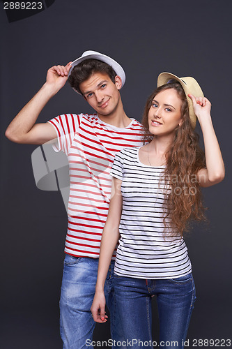 Image of Young casual couple greeting