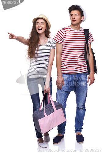 Image of Couple happy tourists pointing to side