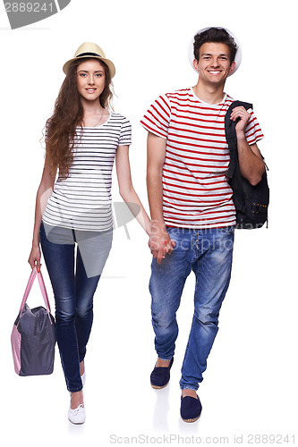 Image of Young couple walking with travel bags