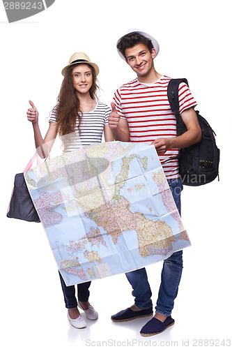 Image of Couple of tourists holding map