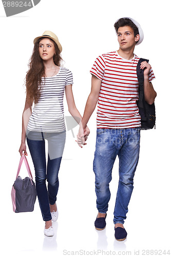 Image of Young couple walking with travel bags