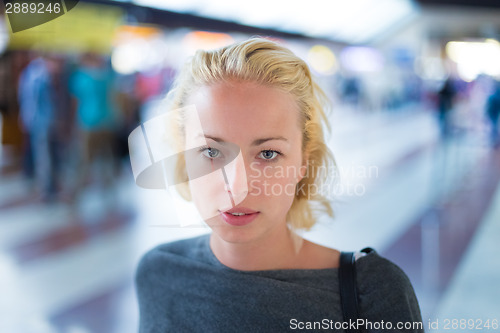 Image of Young woman on platform of railway station.