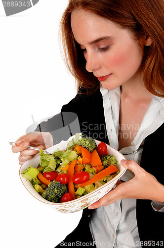 Image of Woman eating salad.