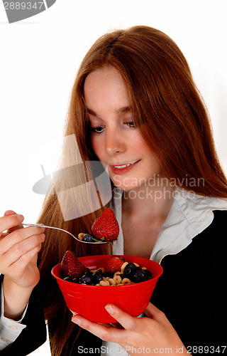 Image of Woman eating breakfast.