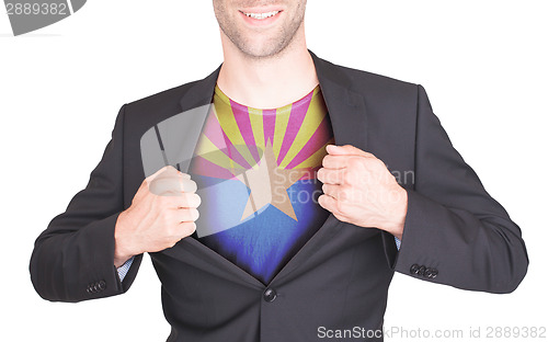 Image of Businessman opening suit to reveal shirt with state flag