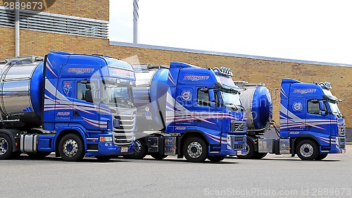 Image of Fleet of Blue Tanker Trucks on a Yard