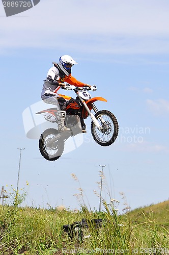 Image of Motorcyclists on motorcycles participate in cross-country race.