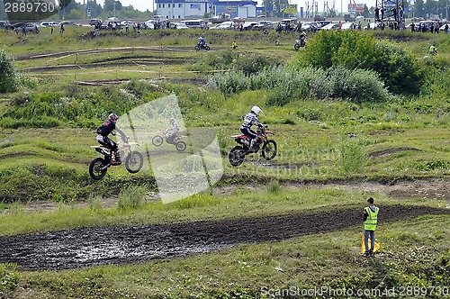 Image of Motorcyclists on motorcycles participate in cross-country race.