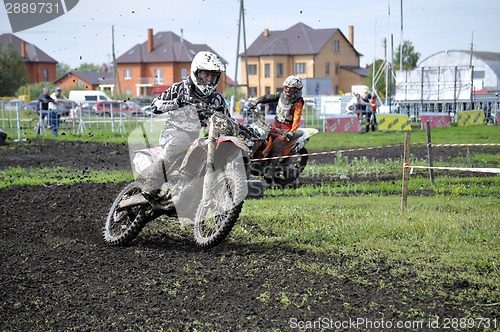 Image of Motorcyclists on motorcycles participate in cross-country race.