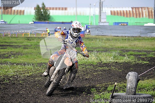 Image of Motorcyclists on motorcycles participate in cross-country race.