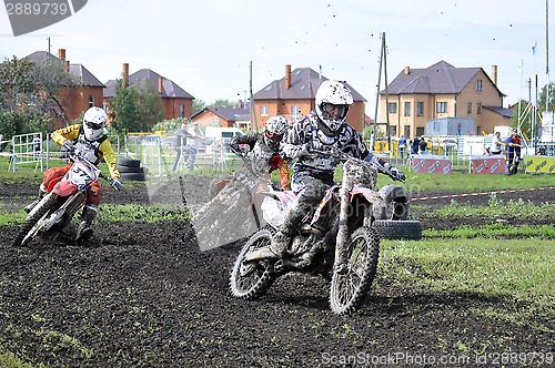 Image of Motorcyclists on motorcycles participate in cross-country race.