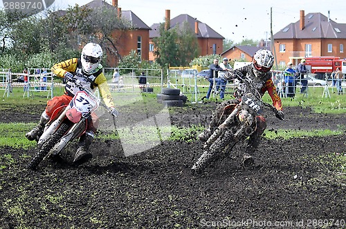 Image of Motorcyclists on motorcycles participate in cross-country race.