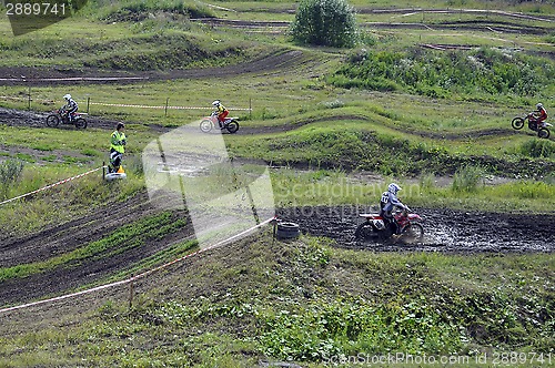 Image of Motorcyclists on motorcycles participate in cross-country race.