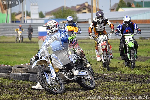 Image of Cross-country race. Motorcyclists on motorcycles enter turn.