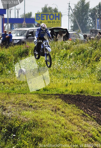 Image of Motorcyclists on motorcycles participate in cross-country race.