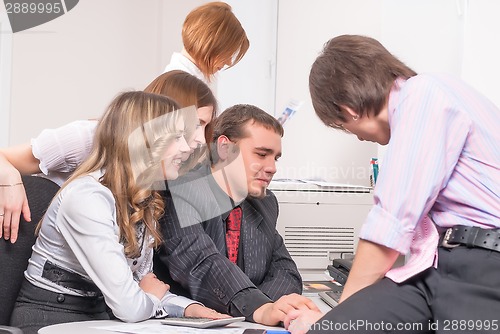 Image of Young business team in front of computer