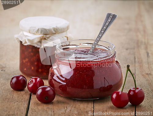 Image of two jars of fruit jam with cherries