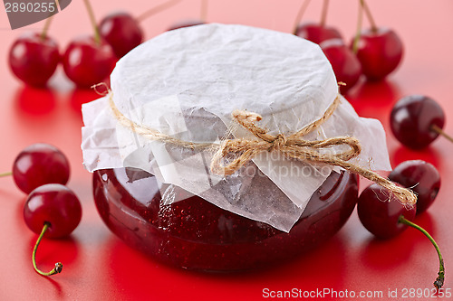 Image of jar of fruit jam with cherries