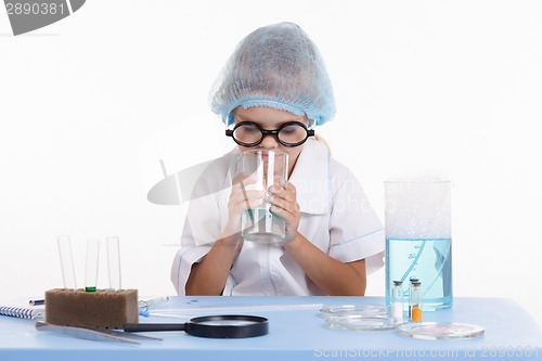 Image of Chemist smelling contents of the flask